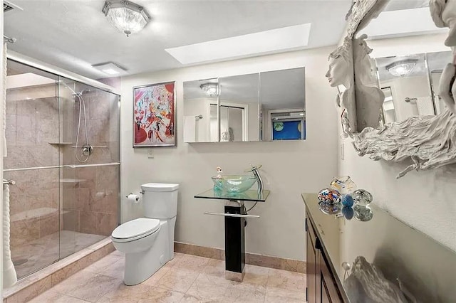 bathroom featuring toilet, a skylight, and a shower with door