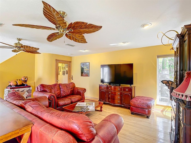 living room featuring ceiling fan and light wood-type flooring