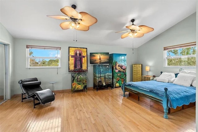 bedroom with ceiling fan, lofted ceiling, and light hardwood / wood-style floors