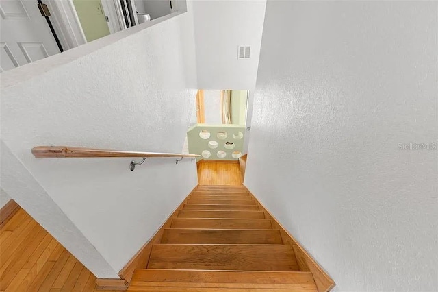 stairway featuring hardwood / wood-style floors