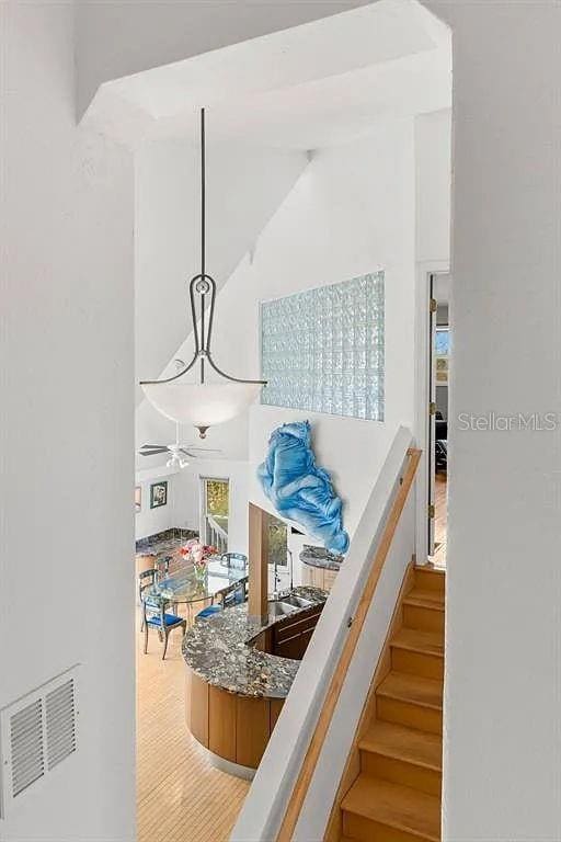 staircase featuring hardwood / wood-style flooring and a towering ceiling