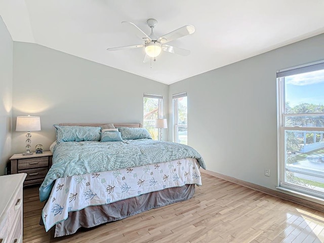 bedroom featuring ceiling fan, lofted ceiling, and light hardwood / wood-style flooring