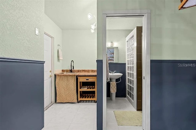 bathroom with tile patterned flooring and sink