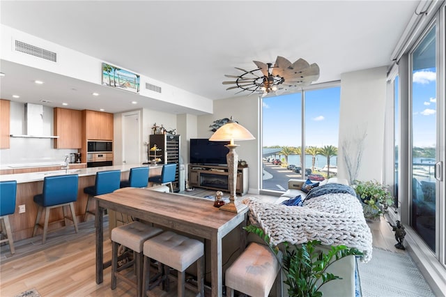 living room with floor to ceiling windows and light hardwood / wood-style flooring