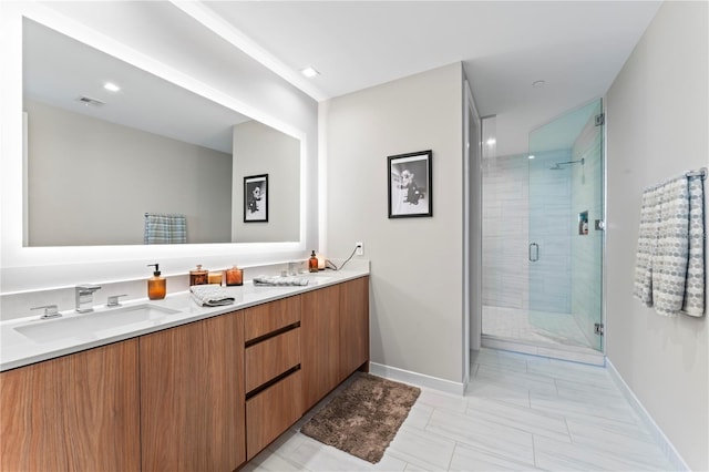 bathroom with vanity and a shower with shower door