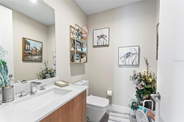 bathroom featuring vanity and toilet