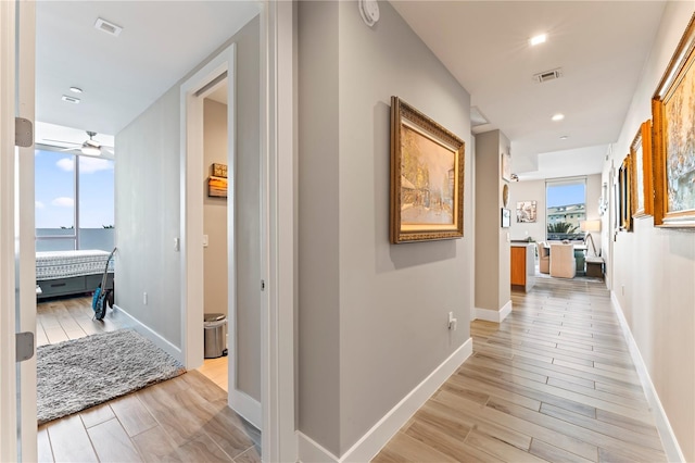 hall with light hardwood / wood-style flooring