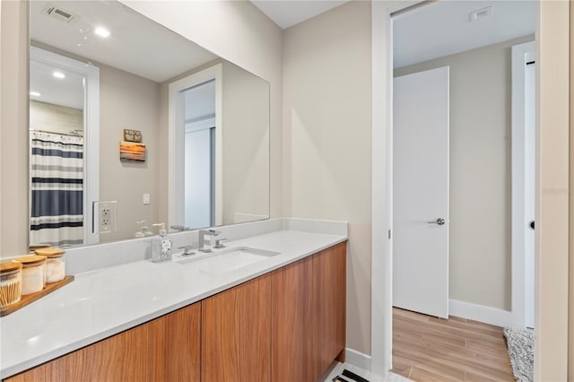 bathroom with vanity and hardwood / wood-style floors