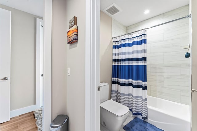 bathroom featuring shower / bathtub combination with curtain, wood-type flooring, and toilet