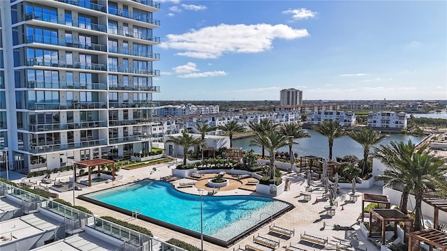 view of pool with a water view and a patio area