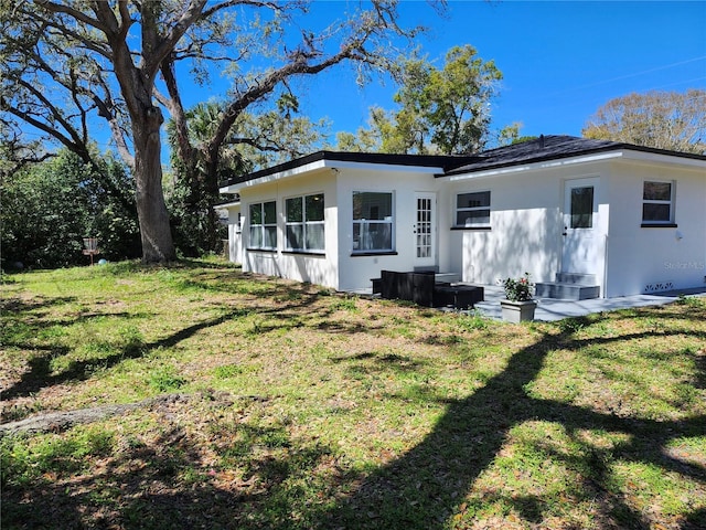 rear view of property featuring a yard