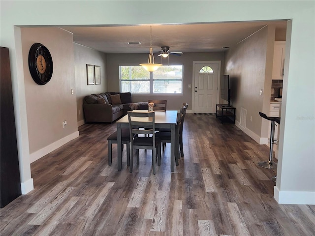 dining room featuring baseboards and dark wood-style flooring