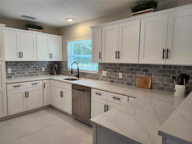 kitchen featuring a sink, visible vents, stainless steel dishwasher, decorative backsplash, and light stone countertops