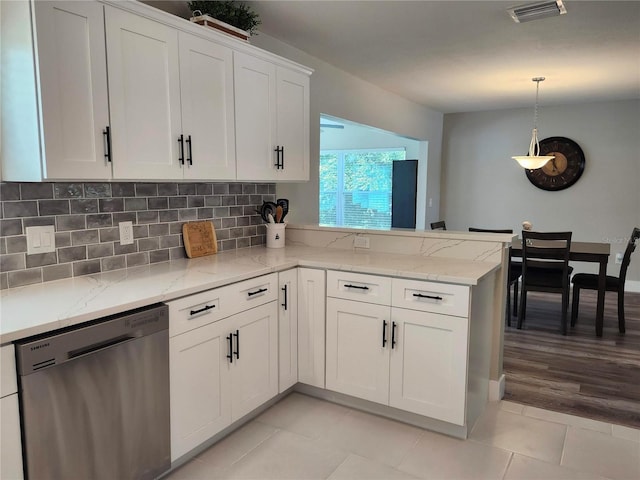 kitchen featuring light tile patterned floors, visible vents, dishwasher, white cabinetry, and backsplash