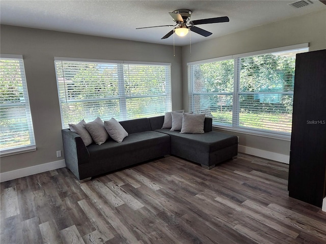 living area featuring wood finished floors, a wealth of natural light, and baseboards