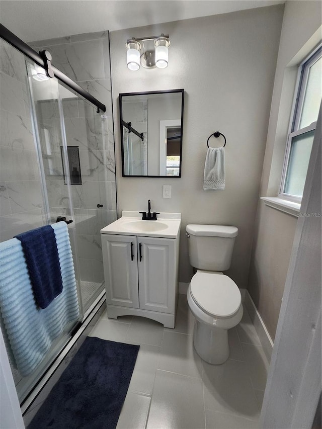 bathroom with vanity, a marble finish shower, toilet, and baseboards