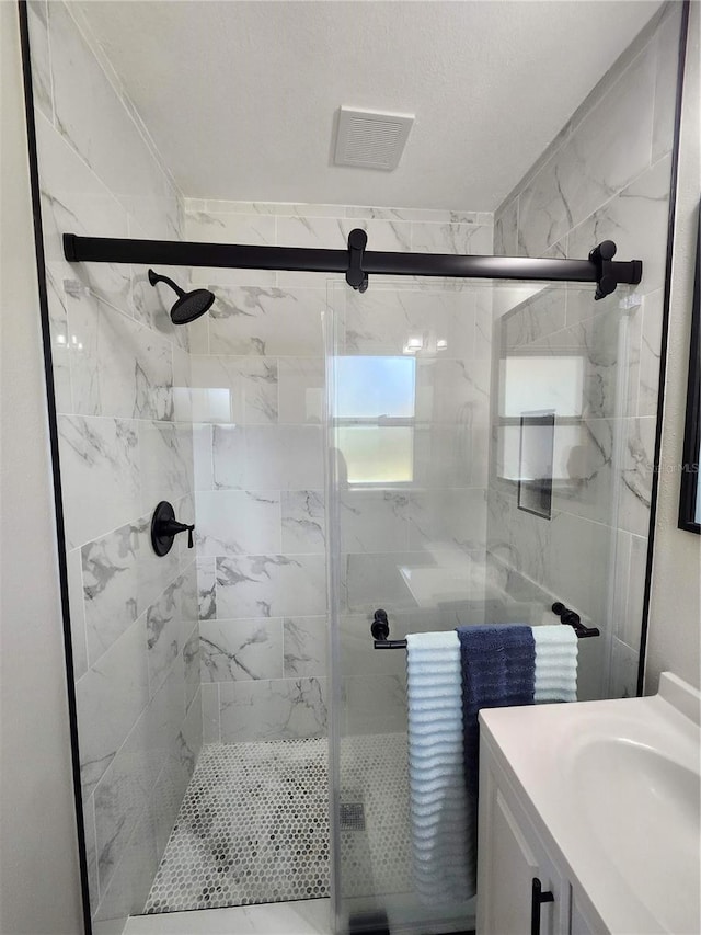 full bath with a shower stall and vanity