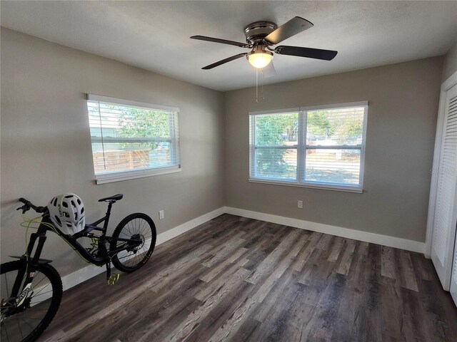 empty room with dark wood-style floors and baseboards