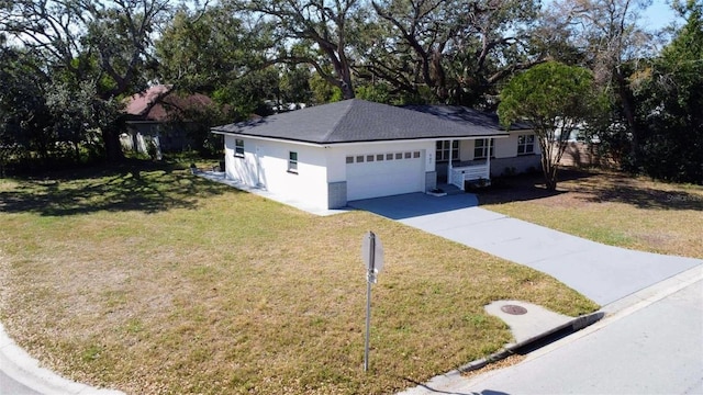 view of front facade with a front lawn, concrete driveway, and an attached garage