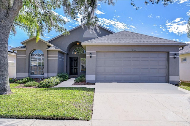 ranch-style home featuring a garage and a front yard