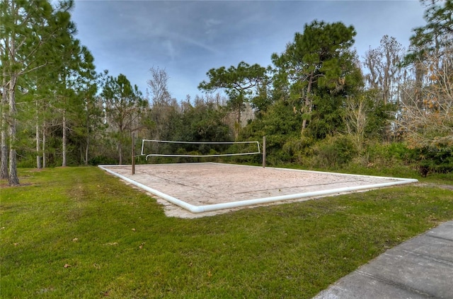 view of home's community featuring a lawn and volleyball court