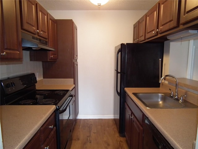 kitchen with hardwood / wood-style flooring, sink, decorative backsplash, and black appliances