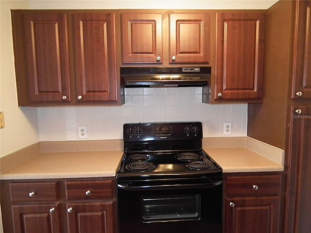 kitchen with backsplash and black / electric stove