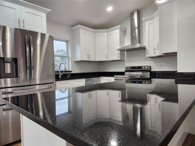 kitchen with white cabinetry, sink, wall chimney range hood, and appliances with stainless steel finishes