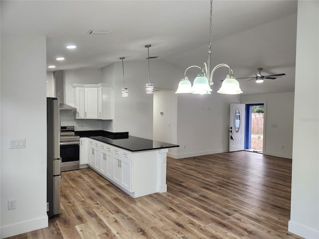 kitchen with kitchen peninsula, white cabinetry, decorative light fixtures, and appliances with stainless steel finishes