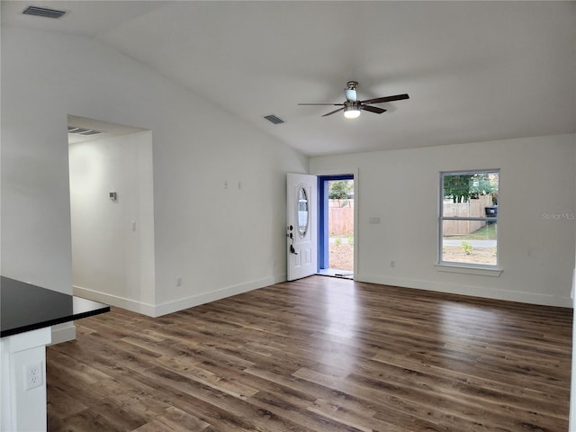 empty room featuring ceiling fan, dark wood-type flooring, and lofted ceiling