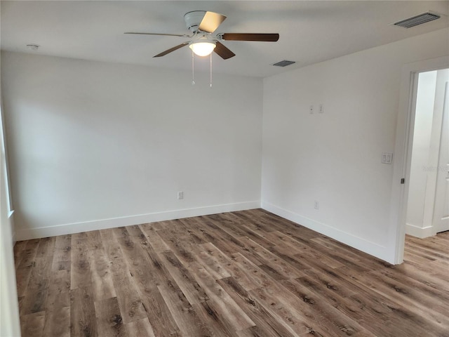 spare room with wood-type flooring and ceiling fan