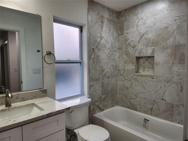 full bathroom featuring a healthy amount of sunlight, toilet, tiled shower / bath, and vanity