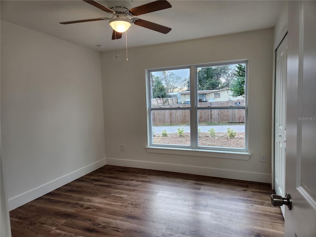 unfurnished room featuring dark hardwood / wood-style floors and ceiling fan