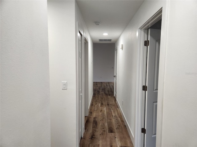 hall with dark hardwood / wood-style flooring