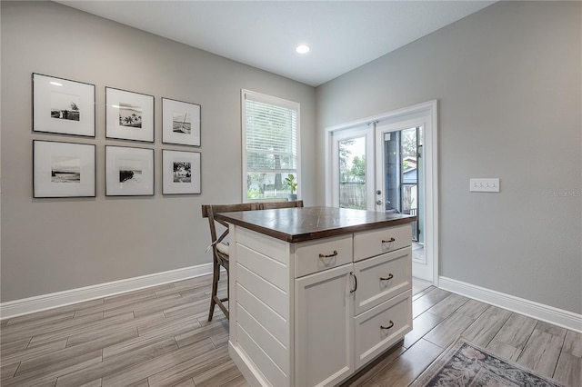 kitchen with a kitchen island and white cabinetry