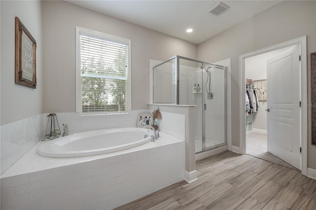 bathroom with separate shower and tub