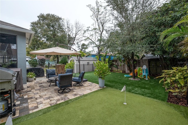 view of yard with a patio area and a playground