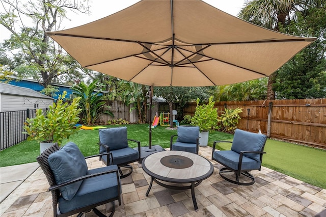 view of patio / terrace with a playground and a fire pit