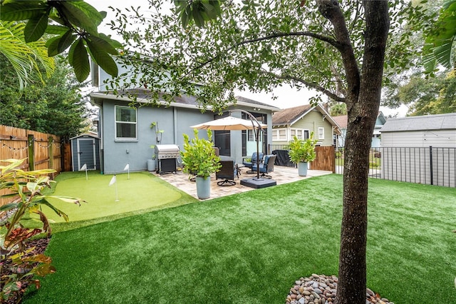 rear view of house with a patio area and a storage shed