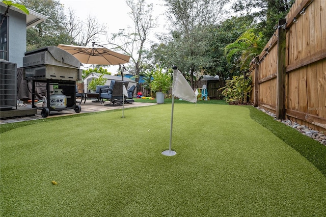 view of yard with a patio and central AC