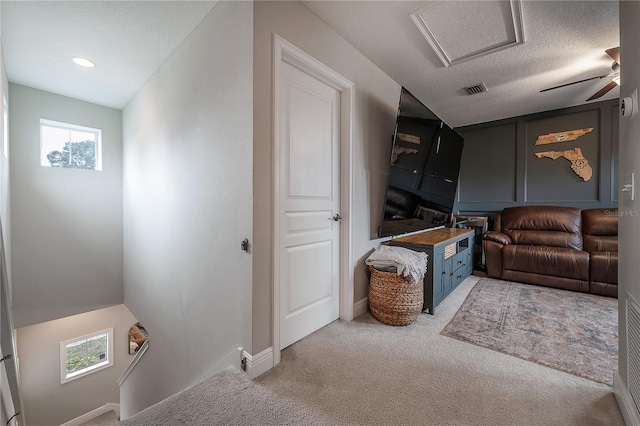 carpeted living room featuring a textured ceiling