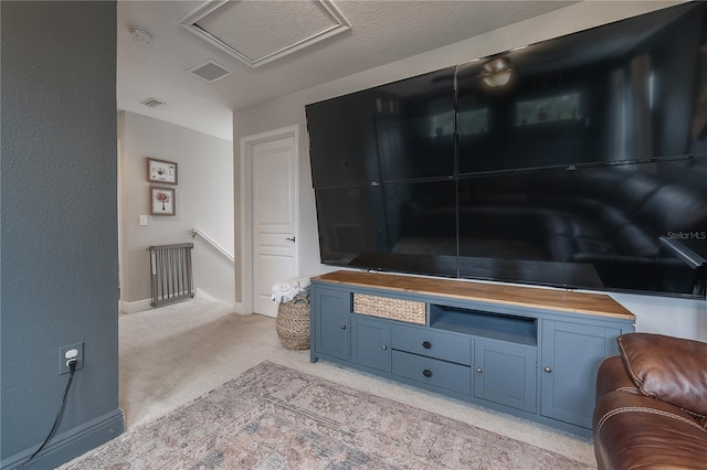 living room featuring a textured ceiling and light carpet