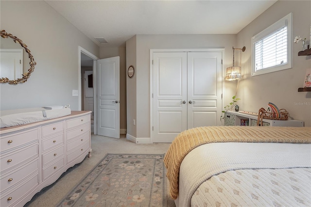 carpeted bedroom with a closet