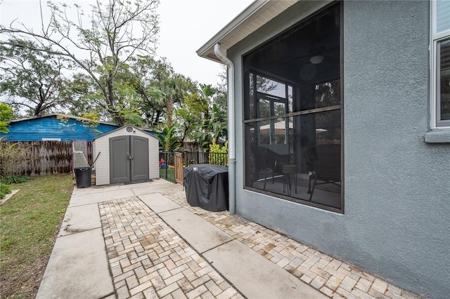 view of patio with a grill and a shed