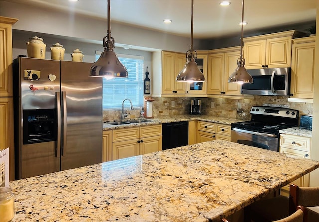 kitchen with sink, tasteful backsplash, decorative light fixtures, and stainless steel appliances