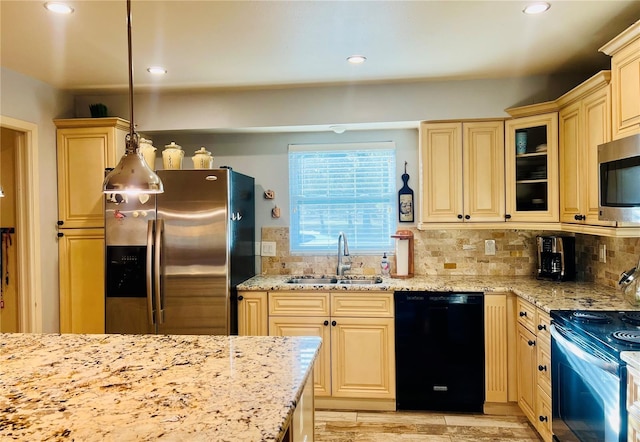 kitchen featuring appliances with stainless steel finishes, sink, decorative light fixtures, light stone counters, and decorative backsplash