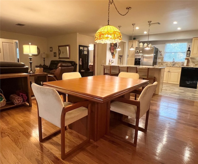 dining space featuring sink and light hardwood / wood-style flooring