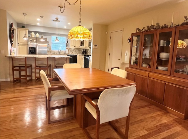 dining space with light wood-type flooring