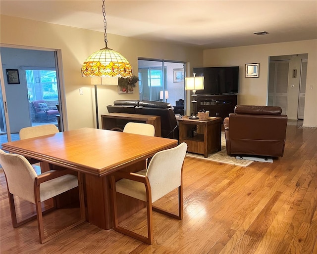 dining space with light hardwood / wood-style flooring