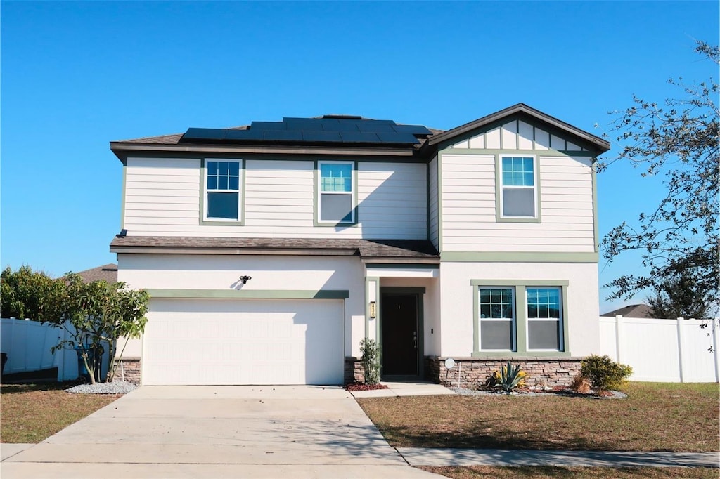 view of front facade featuring a garage and solar panels